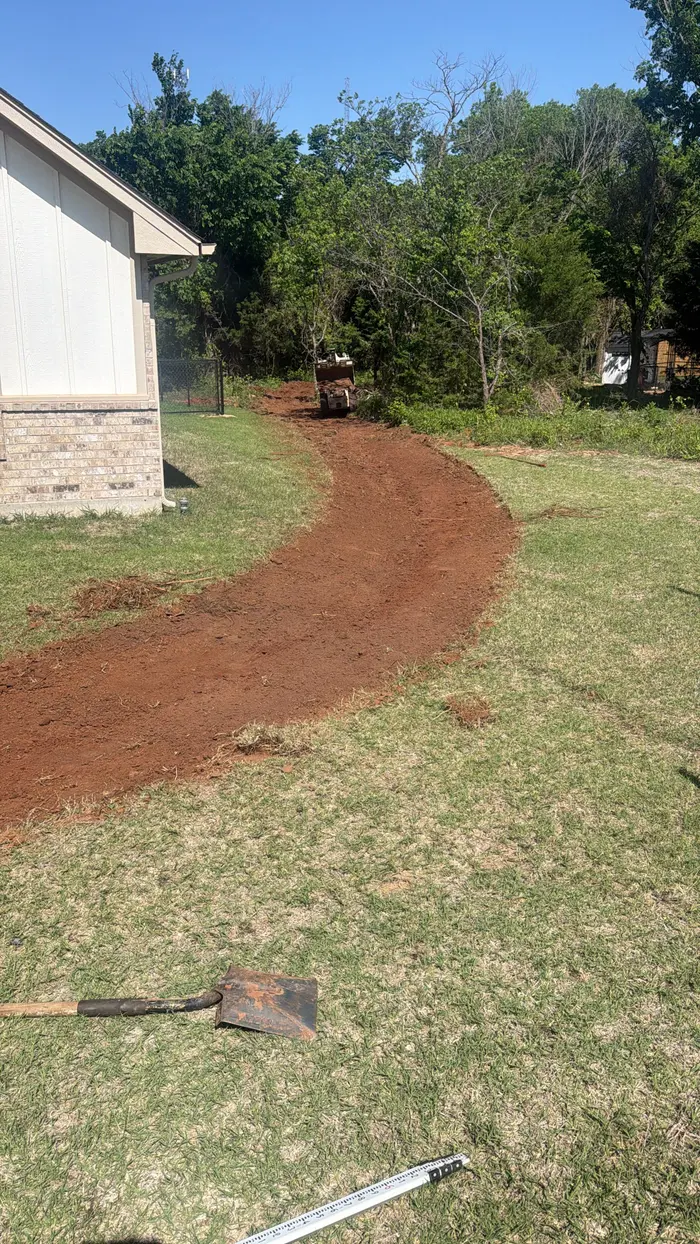 Drainage swale cut curving through a lawn